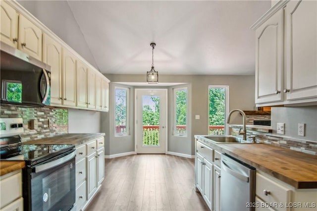 1380 Bluff Dr, Osage Beach, MO 65065 - kitchen with appliances with stainless steel finishes, butcher block countertops, a sink, tasteful backsplash, and lofted ceiling