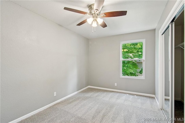 1380 Bluff Dr, Osage Beach, MO 65065 - unfurnished bedroom with carpet flooring, baseboards, a closet, and a ceiling fan