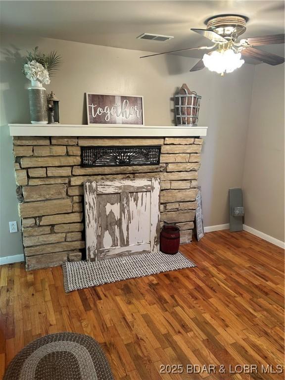 32585 N Ivy Bend Rd, Stover, MO 65078 - unfurnished living room featuring a ceiling fan, wood finished floors, baseboards, and a fireplace
