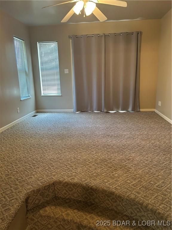 32585 N Ivy Bend Rd, Stover, MO 65078 - carpeted spare room featuring a ceiling fan and baseboards