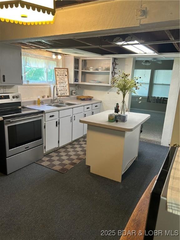 32585 N Ivy Bend Rd, Stover, MO 65078 - kitchen featuring electric stove, a sink, open shelves, a kitchen island, and white cabinets