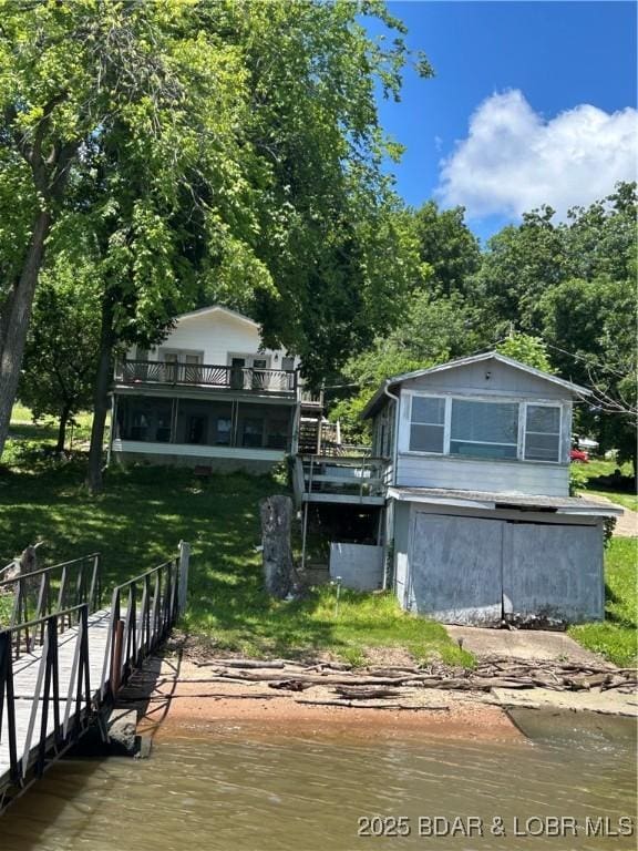 32585 N Ivy Bend Rd, Stover, MO 65078 - dock area with a lawn, a boat ramp, and a deck with water view
