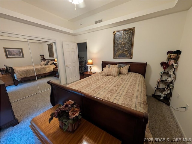 1431 San Jose Dr, Osage Beach, MO 65065 - carpeted bedroom with a tray ceiling, a closet, and baseboards