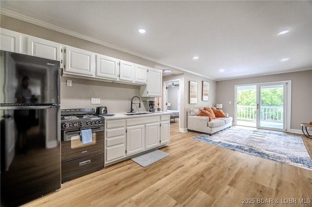 29 Vine St, Edwards, MO 65326 - kitchen featuring black appliances, ornamental molding, light countertops, white cabinets, and open floor plan