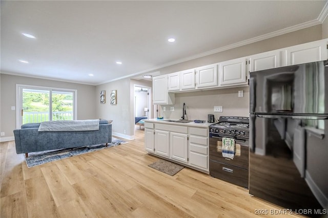 29 Vine St, Edwards, MO 65326 - kitchen featuring black appliances, crown molding, white cabinetry, light countertops, and light wood-type flooring