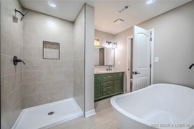 29 Vine St, Edwards, MO 65326 - full bathroom featuring double vanity, a freestanding tub, tile patterned flooring, tiled shower, and recessed lighting