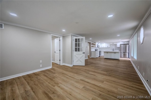 29 Vine St, Edwards, MO 65326 - unfurnished living room with recessed lighting, wood finished floors, and crown molding