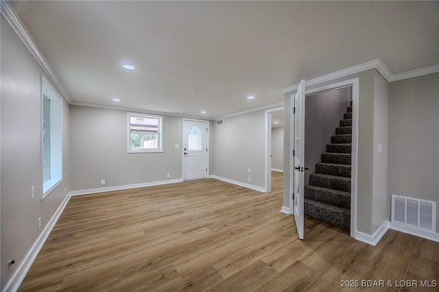 29 Vine St, Edwards, MO 65326 - below grade area with crown molding, stairway, light wood-style flooring, and recessed lighting