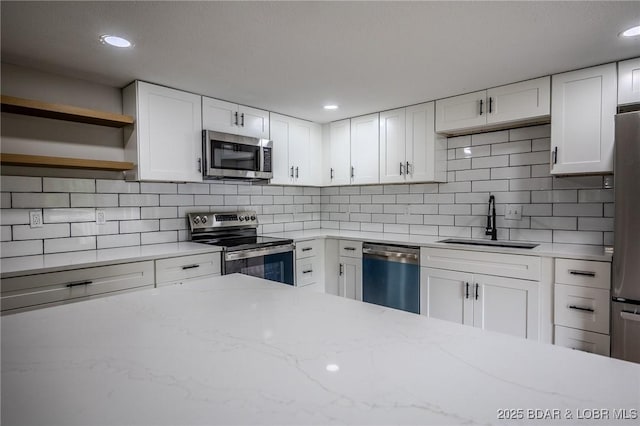 29 Vine St, Edwards, MO 65326 - kitchen with appliances with stainless steel finishes, backsplash, white cabinets, light stone countertops, and open shelves