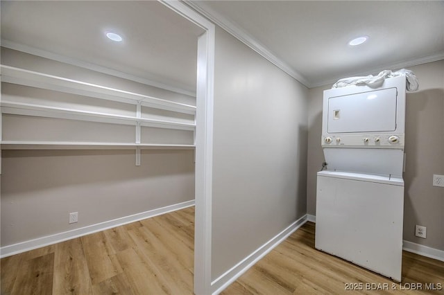 29 Vine St, Edwards, MO 65326 - laundry area with stacked washer and clothes dryer, crown molding, wood finished floors, and recessed lighting
