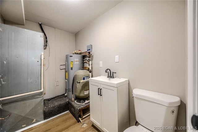 29 Vine St, Edwards, MO 65326 - bathroom with water heater, wood finished floors, vanity, and heating unit
