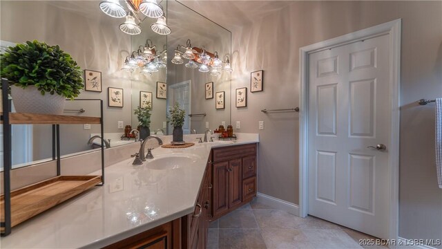 15 Pointe Ct, Lake Ozark, MO 65049 - bathroom with a chandelier, double vanity, tile patterned floors, and baseboards