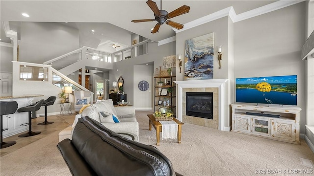 15 Pointe Ct, Lake Ozark, MO 65049 - carpeted living area featuring a ceiling fan, a towering ceiling, a fireplace, ornamental molding, and stairs