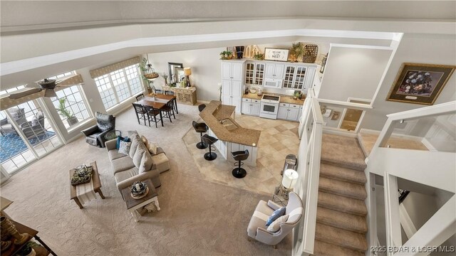 15 Pointe Ct, Lake Ozark, MO 65049 - living area with light carpet, french doors, vaulted ceiling, and stairway