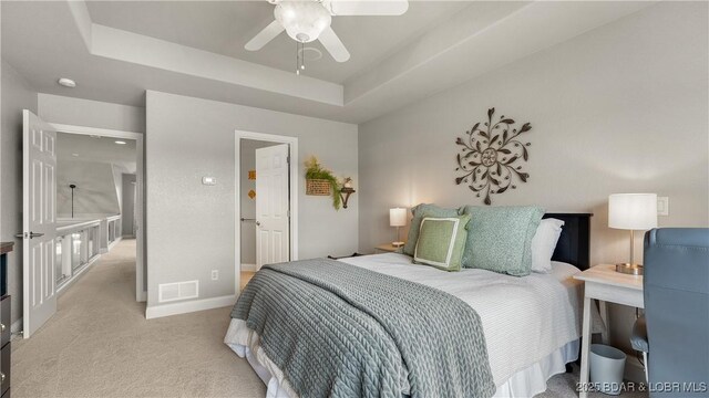 15 Pointe Ct, Lake Ozark, MO 65049 - carpeted bedroom with a tray ceiling, baseboards, and a ceiling fan