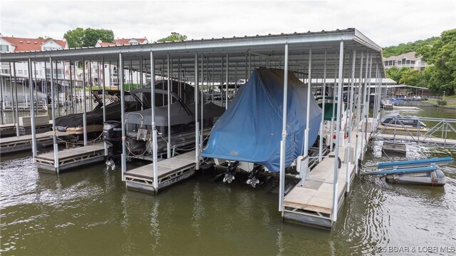 15 Pointe Ct, Lake Ozark, MO 65049 - dock featuring boat lift and a water view