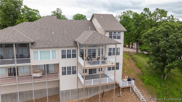 15 Pointe Ct, Lake Ozark, MO 65049 - rear view of house featuring roof with shingles