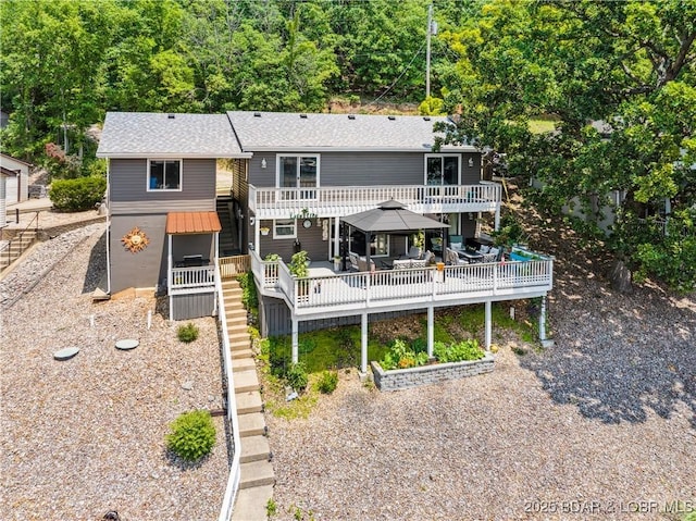 590 Jupiter Rd, Camdenton, MO 65020 - rear view of property featuring a deck, a gazebo, stairway, and roof with shingles