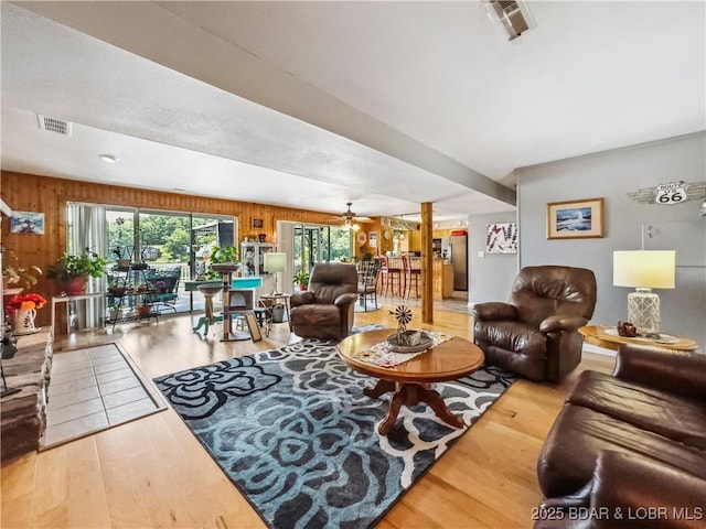 590 Jupiter Rd, Camdenton, MO 65020 - living area with wood finished floors, a ceiling fan, and wood walls
