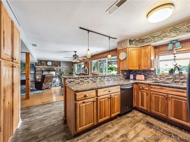590 Jupiter Rd, Camdenton, MO 65020 - kitchen with stainless steel dishwasher, plenty of natural light, wood finished floors, and decorative backsplash