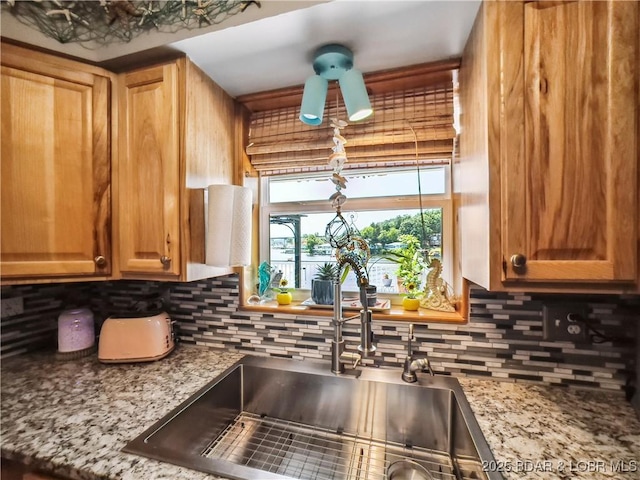 590 Jupiter Rd, Camdenton, MO 65020 - kitchen with tasteful backsplash, ceiling fan, and light stone countertops