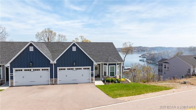 23 Enclaves Ln, Lake Ozark, MO 65049 - view of front facade with board and batten siding, a water view, a shingled roof, a front yard, and stone siding