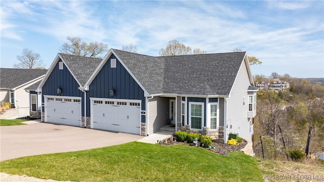 23 Enclaves Ln, Lake Ozark, MO 65049 - view of front of home featuring a shingled roof, stone siding, board and batten siding, a garage, and driveway