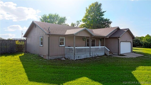 180 Skylark Ln, Linn Creek, MO 65052 - view of front of property featuring a porch, a garage, and driveway
