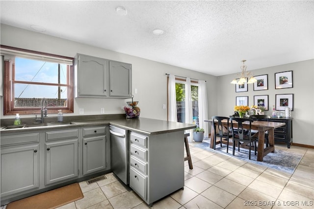 180 Skylark Ln, Linn Creek, MO 65052 - kitchen with a peninsula, gray cabinets, stainless steel dishwasher, a chandelier, and a sink