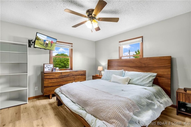 180 Skylark Ln, Linn Creek, MO 65052 - bedroom featuring wood finished floors, a textured ceiling, and ceiling fan