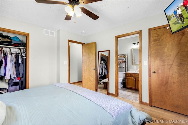 180 Skylark Ln, Linn Creek, MO 65052 - bedroom with light wood-type flooring, a closet, ensuite bathroom, and a ceiling fan
