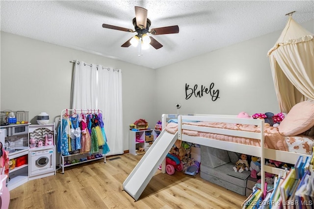 180 Skylark Ln, Linn Creek, MO 65052 - bedroom featuring wood finished floors, ceiling fan, and a textured ceiling