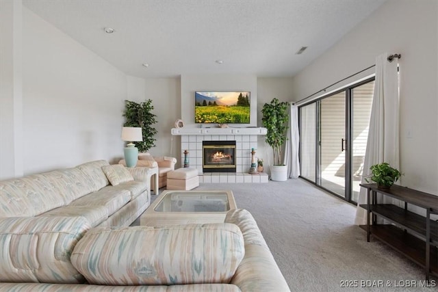 106 Falls Pointe Dr Unit 8C, Lake Ozark, MO 65049 - living room featuring carpet and a tiled fireplace