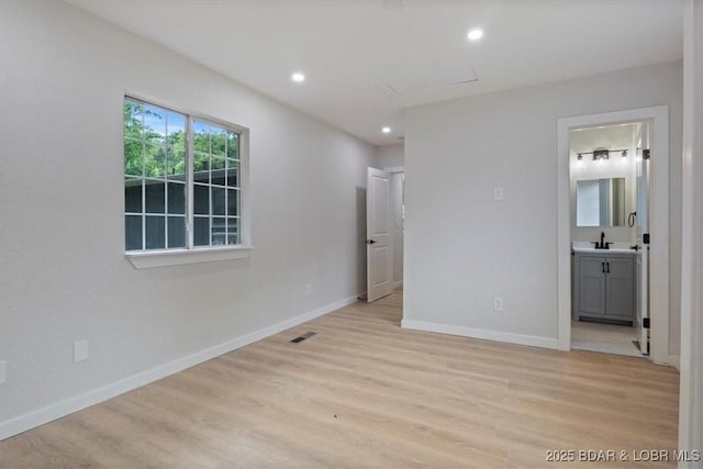13 Leisure Rd, Eldon, MO 65026 - unfurnished bedroom with light wood-type flooring, recessed lighting, and ensuite bath