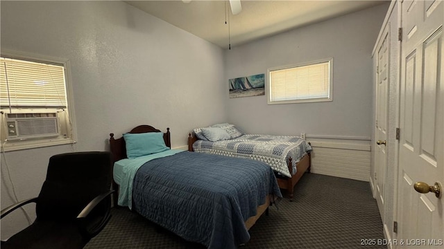 18997 Mystical Ln, Versailles, MO 65084 - carpeted bedroom with cooling unit, multiple windows, and a ceiling fan