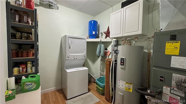 18997 Mystical Ln, Versailles, MO 65084 - laundry area with electric water heater, stacked washer / dryer, cabinet space, light wood finished floors, and heating unit