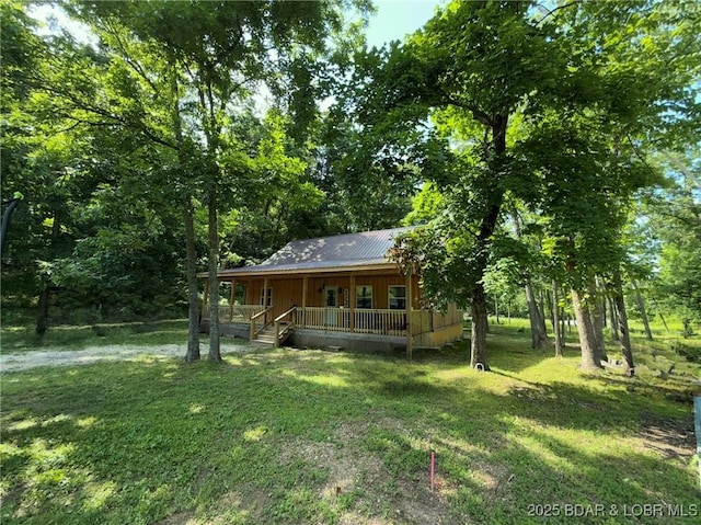 58 Aztec Ln, Eldon, MO 65026 - view of front facade with a porch, a front lawn, and a metal roof