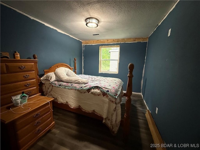 58 Aztec Ln, Eldon, MO 65026 - bedroom with a textured ceiling and dark wood-style flooring