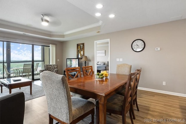 33 Monterey Dr Unit 2A, Lake Ozark, MO 65049 - dining room featuring ornamental molding, a raised ceiling, recessed lighting, and light wood-style floors