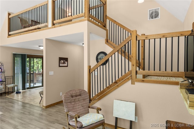 28 Hamilton Way, Sunrise Beach, MO 65079 - staircase featuring wood finished floors and a high ceiling