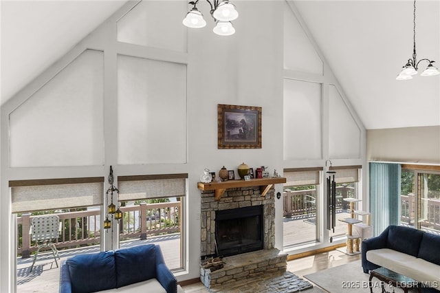 28 Hamilton Way, Sunrise Beach, MO 65079 - living room featuring a chandelier, high vaulted ceiling, a stone fireplace, and wood finished floors