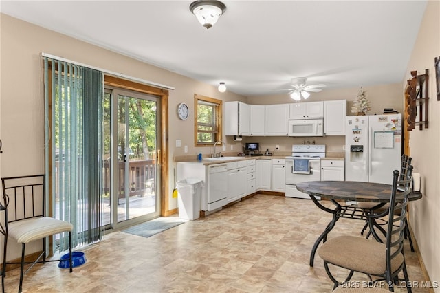 28 Hamilton Way, Sunrise Beach, MO 65079 - kitchen with white appliances, white cabinetry, a ceiling fan, light countertops, and stone finish floors