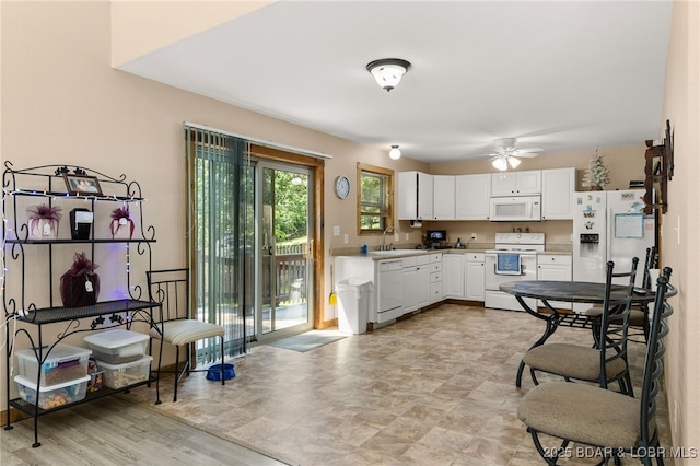 28 Hamilton Way, Sunrise Beach, MO 65079 - kitchen featuring white appliances, a ceiling fan, white cabinetry, and light countertops