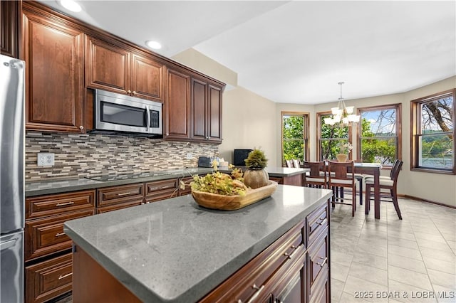 164 Get A Way Ln, Camdenton, MO 65020 - kitchen with appliances with stainless steel finishes, tasteful backsplash, a chandelier, plenty of natural light, and recessed lighting