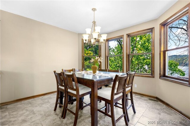 164 Get A Way Ln, Camdenton, MO 65020 - dining room featuring a chandelier and plenty of natural light