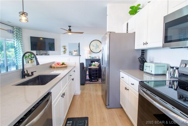 418 Regatta Bay Dr Unit 4A, Lake Ozark, MO 65049 - kitchen featuring stainless steel appliances, white cabinets, light countertops, and ceiling fan