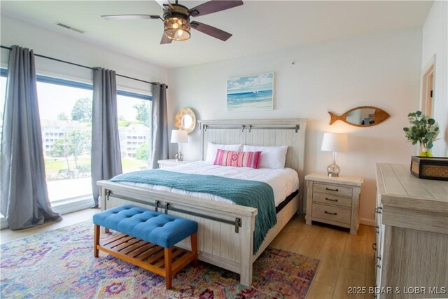 418 Regatta Bay Dr Unit 4A, Lake Ozark, MO 65049 - bedroom with access to outside, light wood-style flooring, and ceiling fan