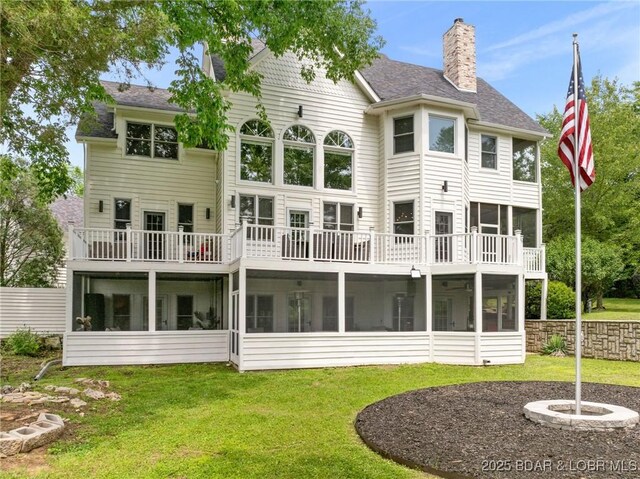 7 Lost Spike Ct, Camdenton, MO 65020 - rear view of property featuring a sunroom, a chimney, a lawn, and a shingled roof