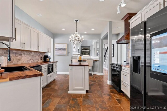 7 Lost Spike Ct, Camdenton, MO 65020 - kitchen with wood counters, electric range oven, decorative backsplash, a chandelier, and white cabinets