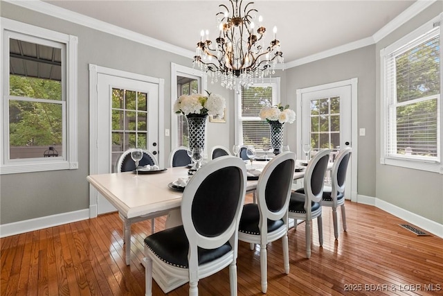 7 Lost Spike Ct, Camdenton, MO 65020 - dining room with a chandelier, healthy amount of natural light, light wood finished floors, and ornamental molding